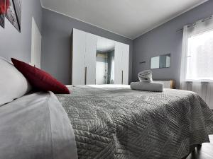 a bedroom with a large bed with red pillows at Alloggio M&M in Padova