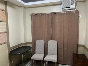 two chairs and a table in a room at St Martin Village unit 2B in Mandaue City
