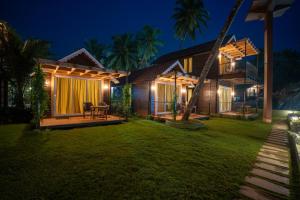 a house with a garden at night at Marron Sea View Resort in Patnem