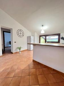 a kitchen with a tile floor and a clock on the wall at Casa Sopra in Castel di Sangro