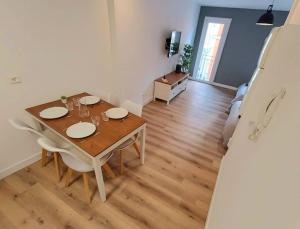 a dining room with a wooden table and chairs at L Angelus in Lourdes +7 photos
