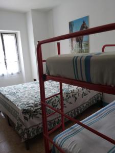 two bunk beds in a room with a window at Azzone Cascina nel verde in Azzone