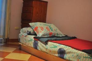 a bedroom with a bed with a pillow and a dresser at Nights of the Orient in Sharm El Sheikh +6 photos