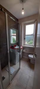a bathroom with a shower and a toilet and a window at Gestiona2R - Narganes Mar y Montaña, ideal familias in Narganes +30 photos