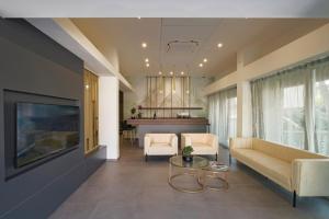 a living room with a couch and a table at Residence Goldoni 6 Suite Apartment in Rimini
