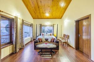 a living room with a couch and a table at Alaya Stays 2 BHK with Garden & Balcony - Villa Harmony in Bhowāli +45 photos