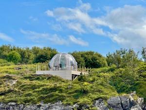 a glass dome on top of a hill at Atlantic Dome in Skotten