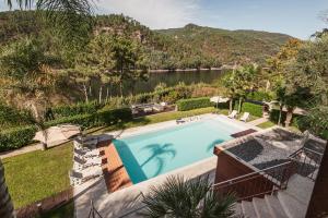 an outdoor swimming pool with a view of a lake at Quinta da Mimosa in Vieira do Minho