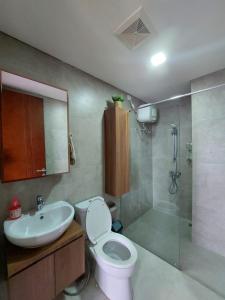 a bathroom with a toilet and a sink and a shower at Zahra Sea View 2BDR Apartment Pollux Habibie Batam in Batam Center