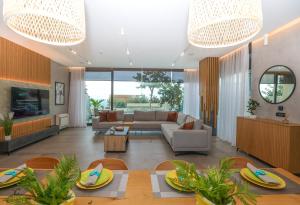 a living room with a couch and a table at Green Coast Resort V94 in Palasë