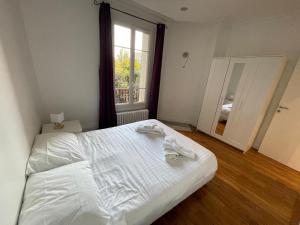 Ένα ή περισσότερα κρεβάτια σε δωμάτιο στο Appartement à Gentilly, à 2 pas de Paris