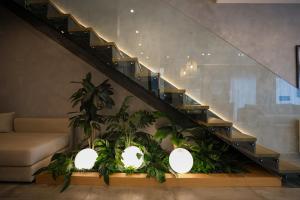 a living room with a staircase with potted plants at Green Coast Resort V94 in Palasë