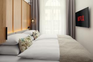 a bedroom with two white beds and a window at R16 Residences Prague in Prague