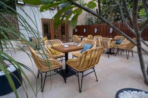 a group of chairs and tables in a patio at Boutique Residence Iconia-Lemon Spaces Zamalek in Cairo