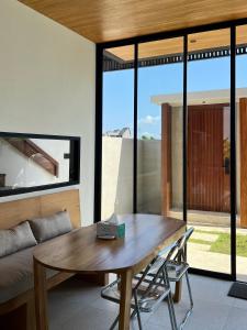 a living room with a wooden table and a couch at Seaside Temple Pererenan in Canggu