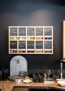 a kitchen with a counter with a wall with chalkboards at Family Resort Rainer Sexten in Sesto