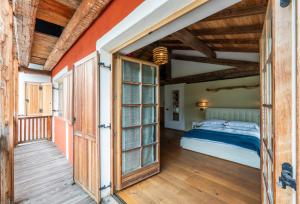 sypialnia z łóżkiem i otwartymi drzwiami w obiekcie Hotel Relais Vecchio Maso w Trydencie +37 zdjęć