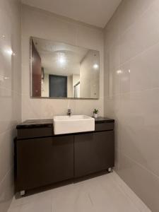 a bathroom with a sink and a mirror at Muji Full Seaview Royal Strand with 2CarParks FOC Netflix Access and Youtube Premium 3Beds 3Bath for 6-12pax by Minshuku in Johor Bahru