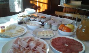 a table topped with plates of meats and other foods at Huberhof Abendsonne in Terento