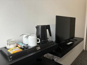 Příslušenství pro přípravu čaje a kávy v ubytování Hotel Pangea
