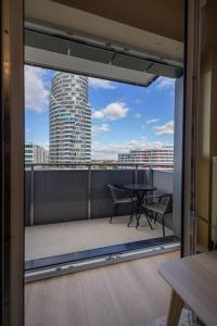 a balcony with a table and a view of a building at VIP Apartament Kopisto CENTRUM in Rzeszów