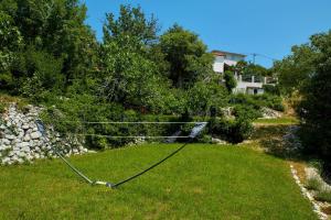 a yard with a net in the grass at Villa Eugenia for 8 people with private pool & large garden only 3 km from the beach in Mošćenička Draga