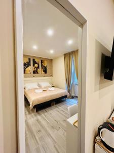 a hotel room with a bed and a mirror at Domus Altino in Rome
