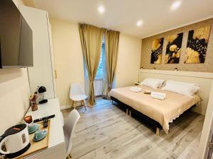 a hotel room with a bed and a table and chairs at Domus Altino in Rome +33 photos