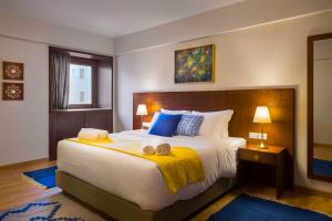 a bedroom with a large bed with towels on it at Boutique Residence Iconia-Lemon Spaces Zamalek in Cairo +98 photos