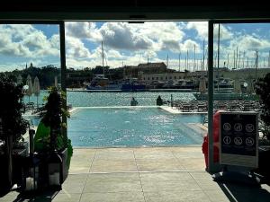 a swimming pool with a boat in a marina at Sunny 2 BR Aptm with Garden Fast WiFi Walk to Seafront in Il-Gżira