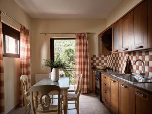 a kitchen with a table and a dining room at Rosa Sea Front Maisonette in Alikanas