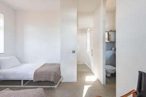 a white bedroom with a bed and a toilet at Coastguard Lookout by Bloom Stays in Littlestone-on-Sea