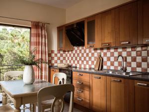 cocina con mesa y fregadero en Rosa Sea Front Maisonette, en Alikanas 12 fotos más