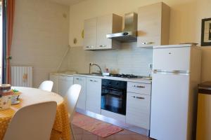 a kitchen with a white refrigerator and a table at Gioiamare in Martinsicuro +41 photos