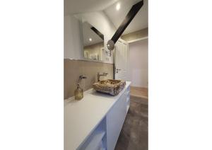 a bathroom with white counters and a sink at 5 Sterne Ferienwohnung Dewichow mit Wasserblick & WLAN in Dewichow +36 photos