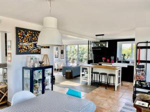 a living room with a kitchen and a dining room at VILLA DU BILLOU Repos et plaisirs de la mer in Santec