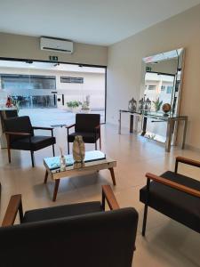 a living room with a couch and a table at Seleto Hotel Express in Arrozal