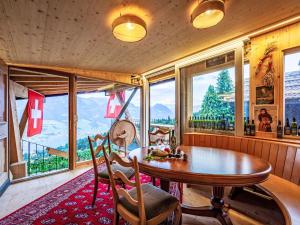 ein Esszimmer mit einem Tisch und Bergblick in der Unterkunft Holiday Home Chalet Zun 6B by Interhome in Sarnen