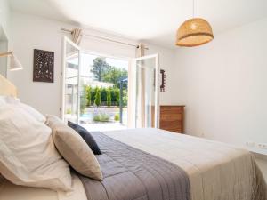 a bedroom with a bed and an open door at Holiday Home Villa D'Allongue by Interhome in Callian