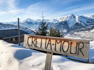 a sign in the snow with a view of the mountains at Chalet Crettamour by Interhome in Veysonnaz