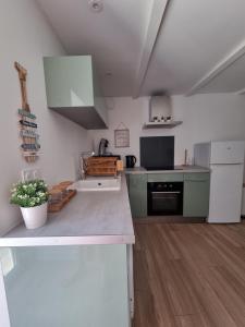 a kitchen with a sink and a counter top at Maison cosy rénovée, proche de Carcassonne in Villarzel-Cabardès +11 photos
