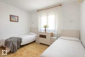 Łóżko lub łóżka w pokoju w obiekcie Villa Nani by Abahana Villas