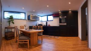 a kitchen with a wooden table and a dining room at Ferienwohnung-Claudia in Schwerin in Schwerin +16 photos