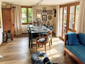 a living room with a table and a blue couch at Holiday Home Chalet Tannengüetli by Interhome in Grindelwald