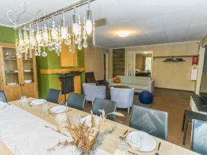 a dining room with a long table and chairs at Holiday Home Villa kallahti beach view helsinki by Interhome in Helsinki