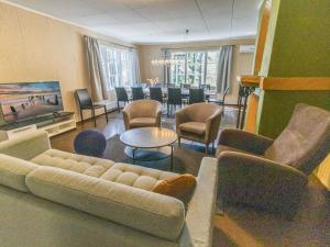 a living room with a couch and chairs and a table at Holiday Home Villa kallahti beach view helsinki by Interhome in Helsinki