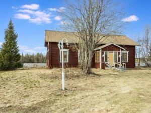 a small house with a sign in front of it at Holiday Home Ounasmosku by Interhome in Tepasto