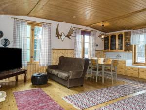 a living room with a couch and a table at Holiday Home Ounasmosku by Interhome in Tepasto +20 photos