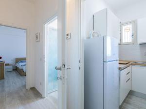 a kitchen with a white refrigerator in a room at Apartment Franca by Interhome in San Vincenzo +17 photos