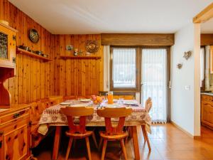 a dining room with a table with chairs and wooden walls at Apartment Apt 18 by Interhome in Campitello di Fassa +36 photos